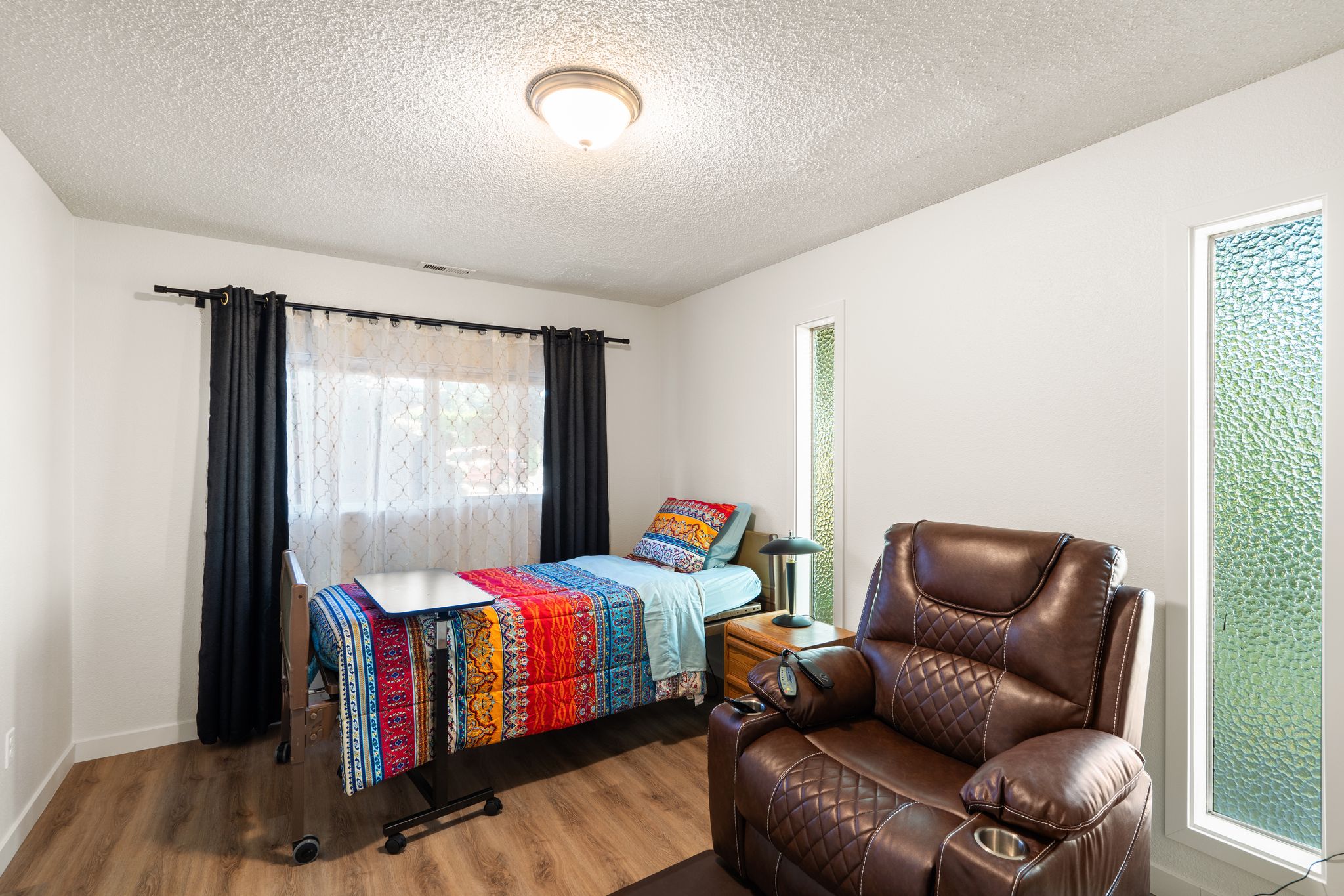 Private bedroom with comfortable furnishings and personal space for residents